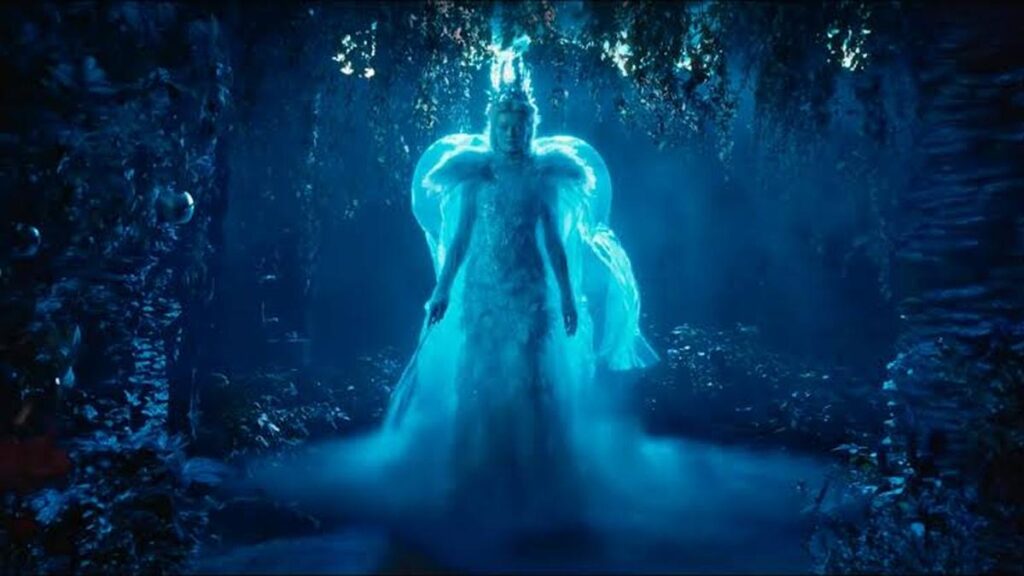 Two figures in a glowing blue wood in Narnia: The Magician’s Nephew